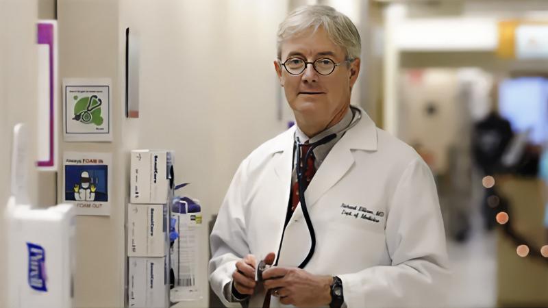 Dr. Richard Ellison, a infectious disease physician at UMass, stands in a hospital corridor.