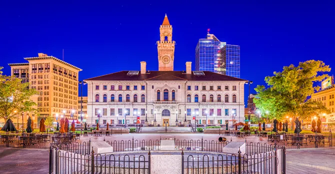 he Worcester City Hall is shown against a dark blue sky.