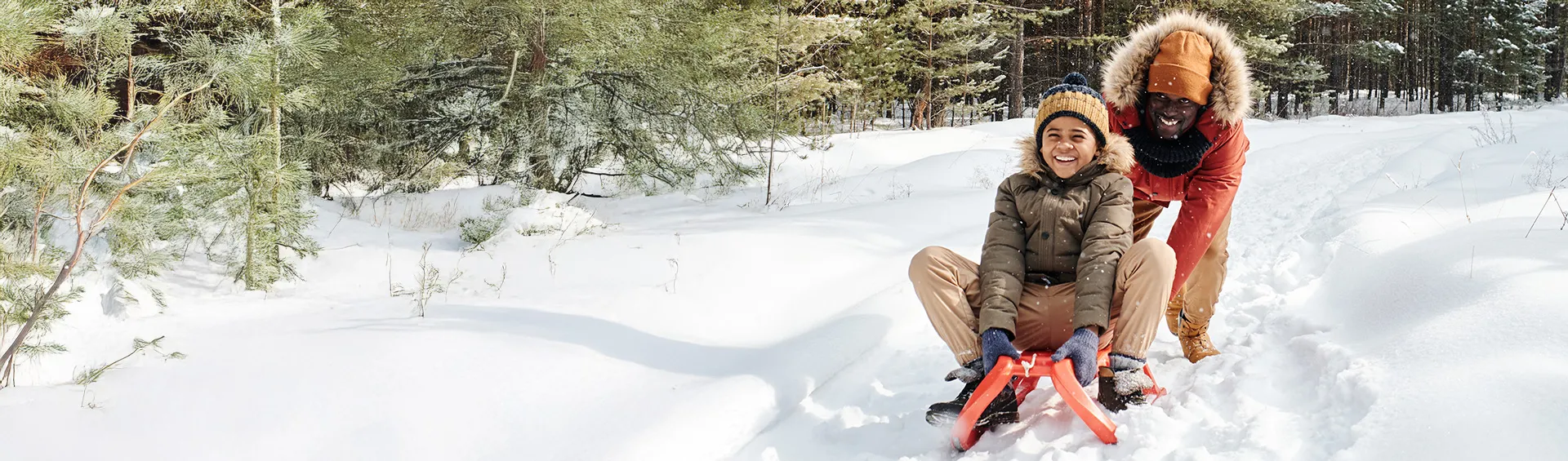 Image of a father and son sledding