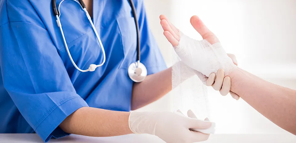 Image of caregiver wrapping a arm of patient