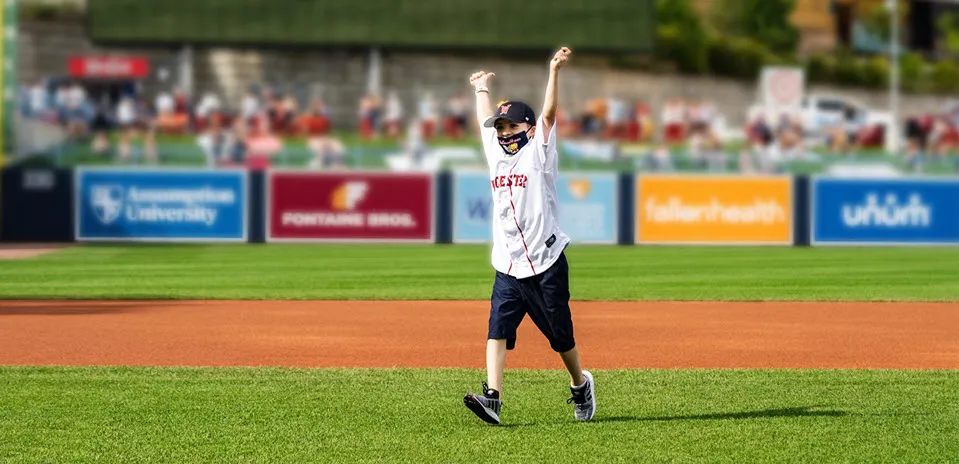 A young boy named Jamison is running on the field of Polar Park before a WooSox game.