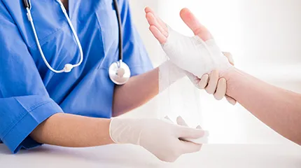 Image of doctor wrapping person's arm