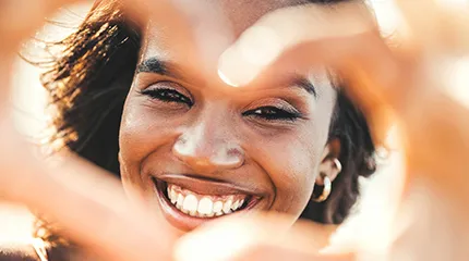 Image of woman making a heart with her hands