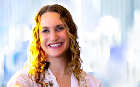 UMass Memorial Health caregiver Lauren Feld on a blue background.