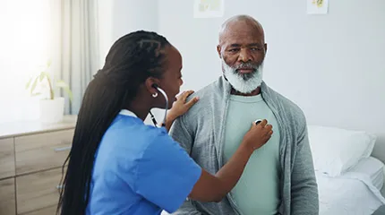 Woman advanced practice practitioner listens to patient's heart