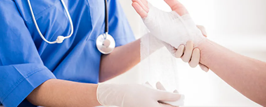 Image of doctor wrapping person's arm