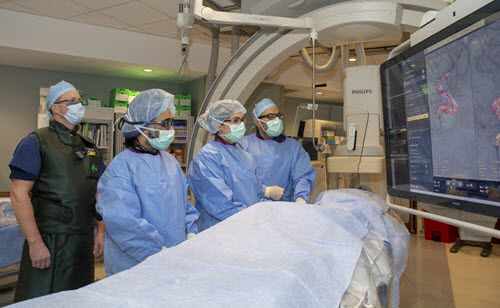 Medical professionals performing a procedure in radiology.